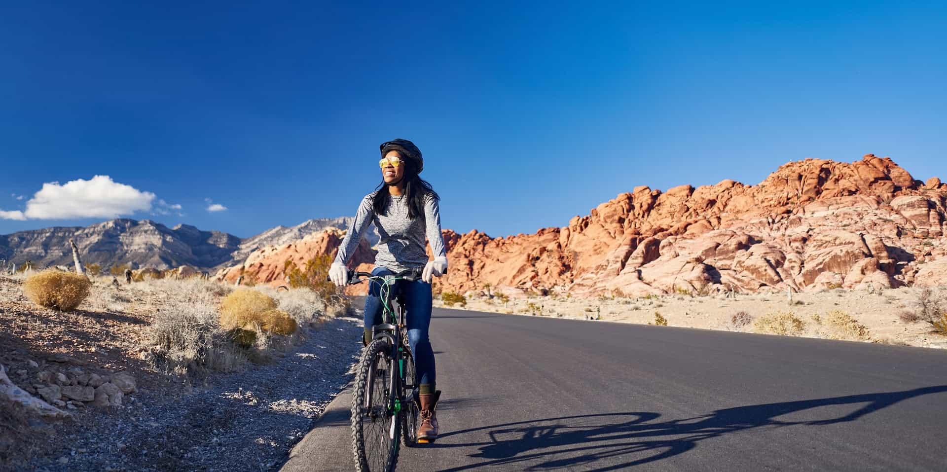 Smiling woman riding a bike